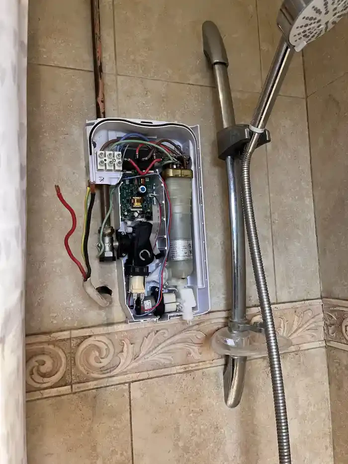 Modern electric shower installation in Exeter bathroom