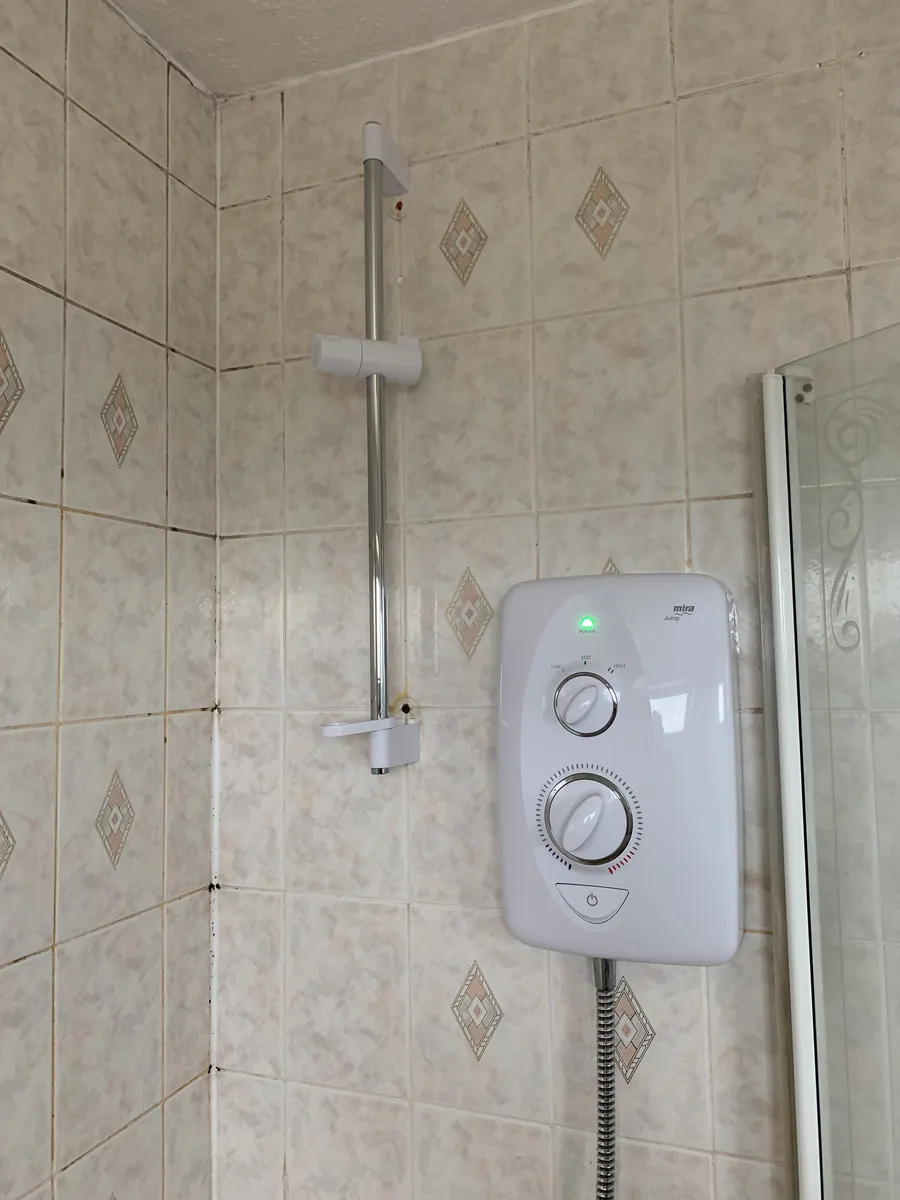 Mira electric shower fitted in a tiled bathroom, Exeter