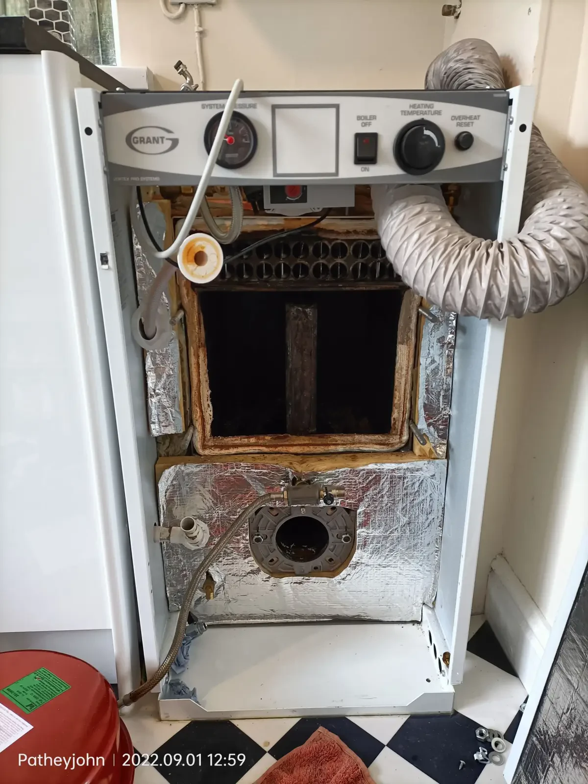 Gas Safe registered heating engineer checking a boiler in Exeter before a power flush