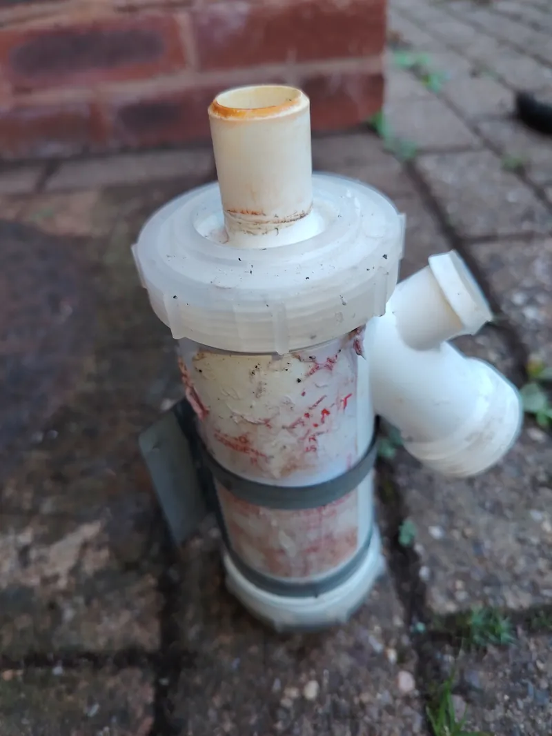 Grant oil boiler condensate trap removed for cleaning during a service in Shillingford St George, Exeter