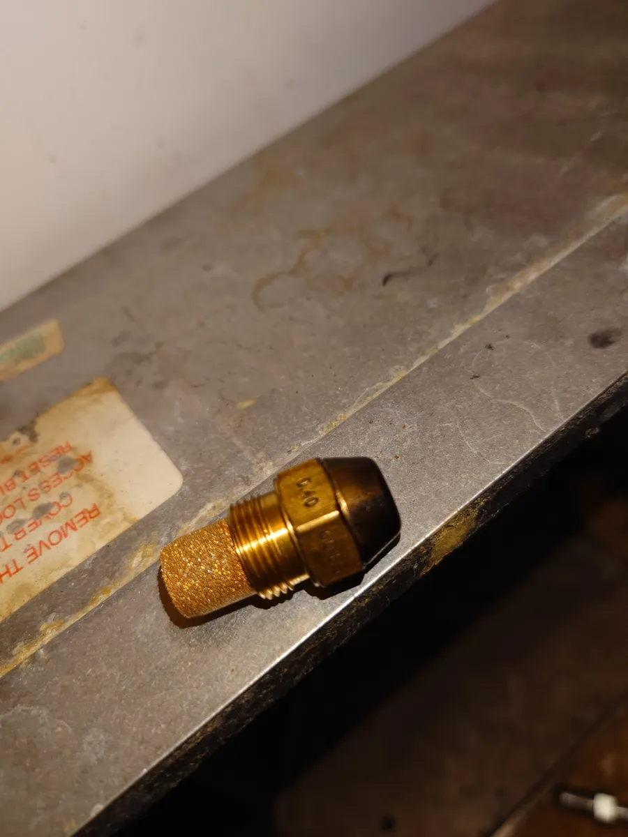 Brass oil burner nozzle being replaced during a service in Exeter
