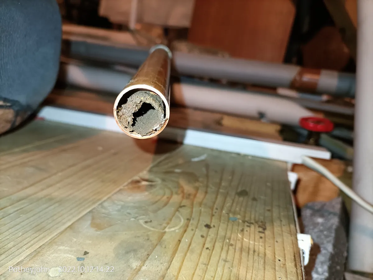 End of a blocked central heating pipe packed with sludge, removed during a power flush in Exeter