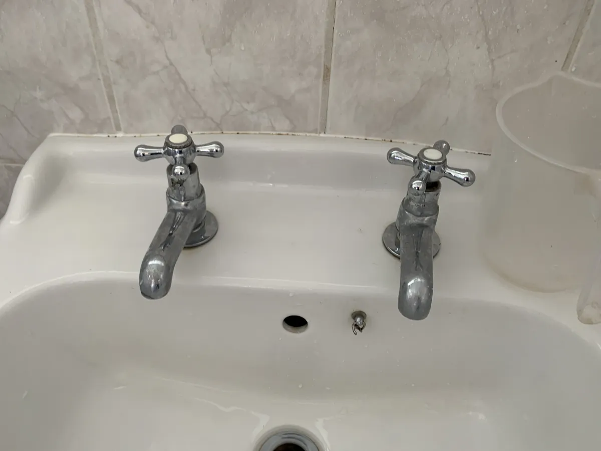 Traditional pillar taps on a basin in an Exeter bathroom